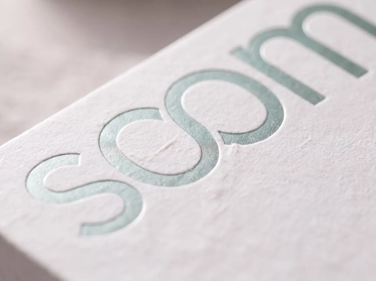 Mint foil soom wordmark pressed into textured paper