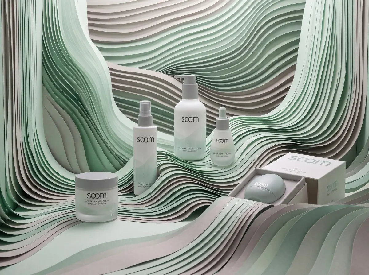 The soom range set into layered mint and white paper waves